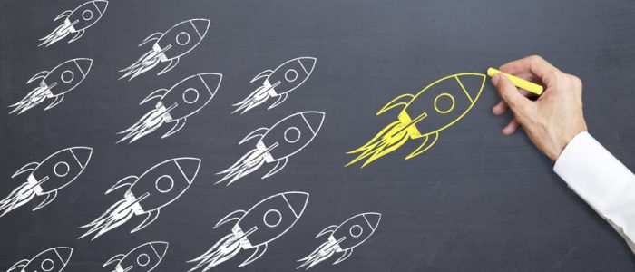 business man is drawing yellow rocket on blackboard with chalk. rising concept